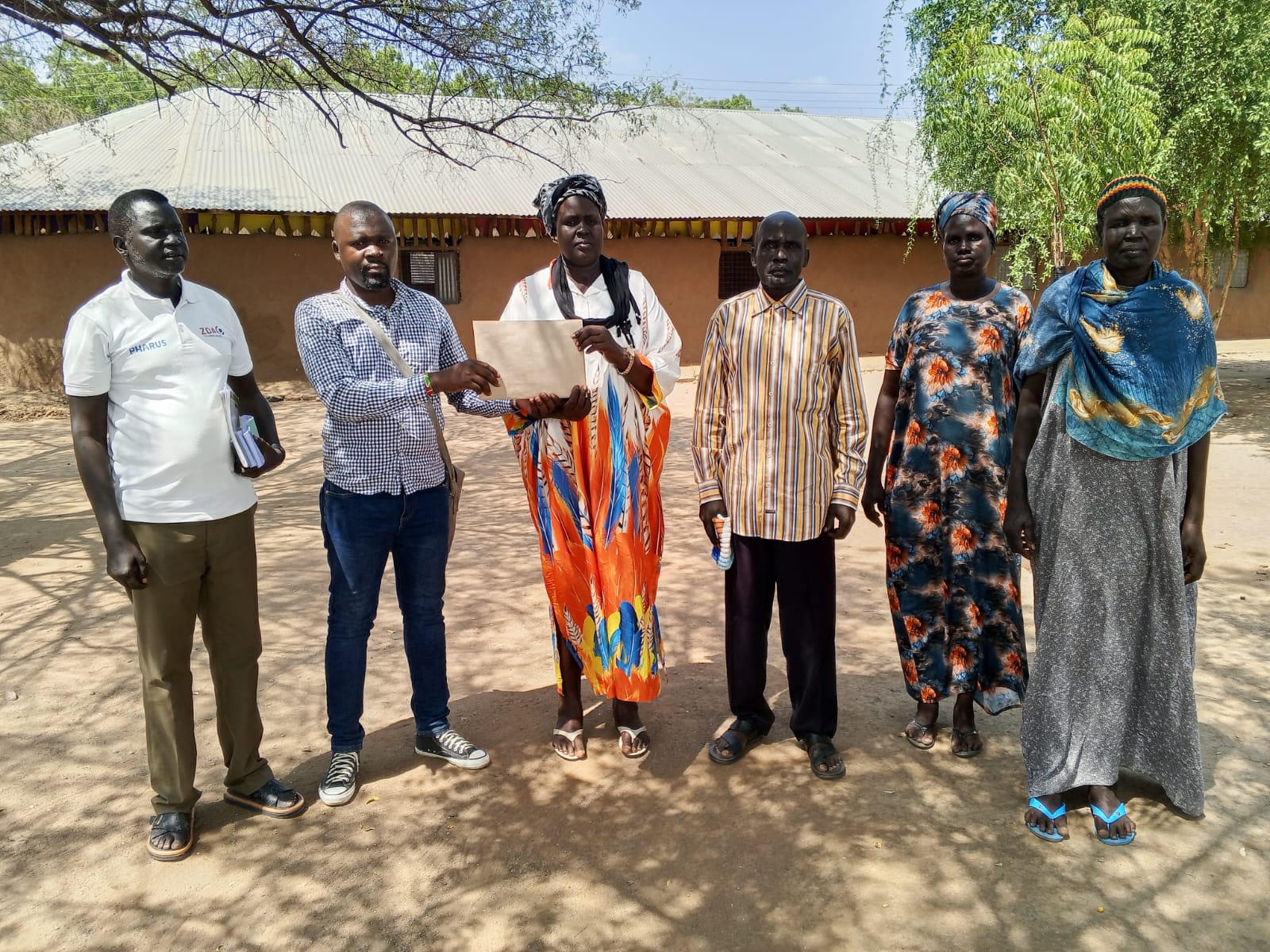 BOM Chairperson Rev. Deacon Rachel Abuk Marial receiving the school auditing report on 23 July 2026.